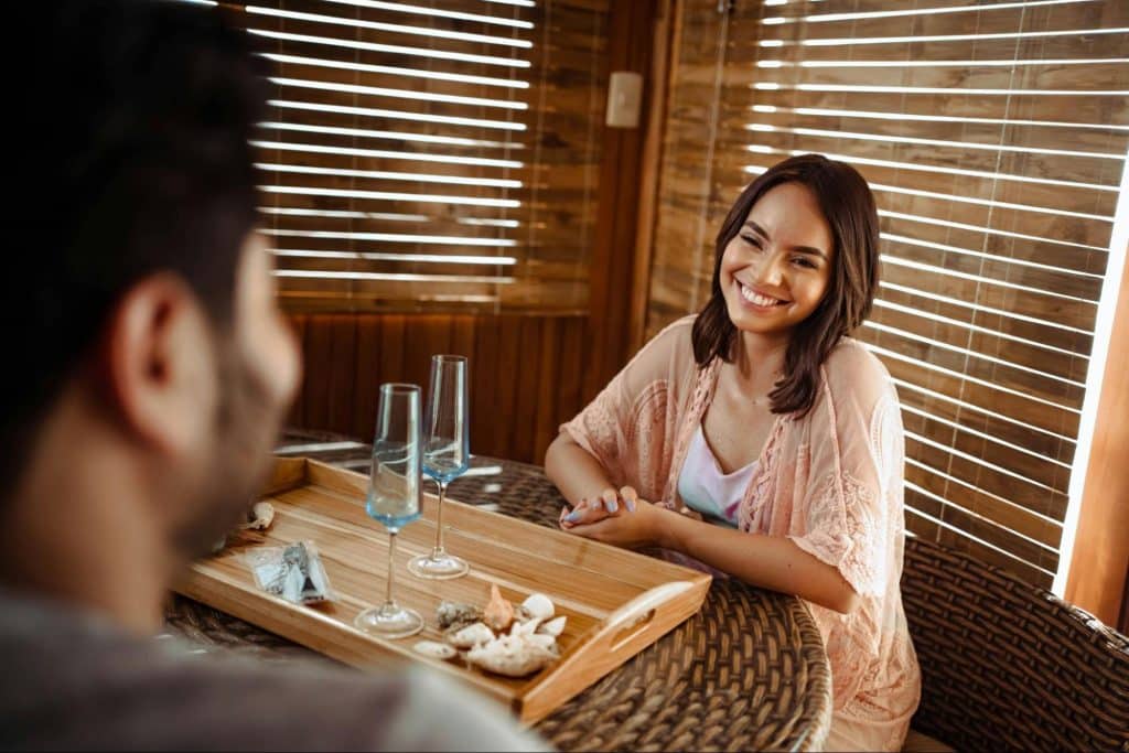 A woman smiling at the man