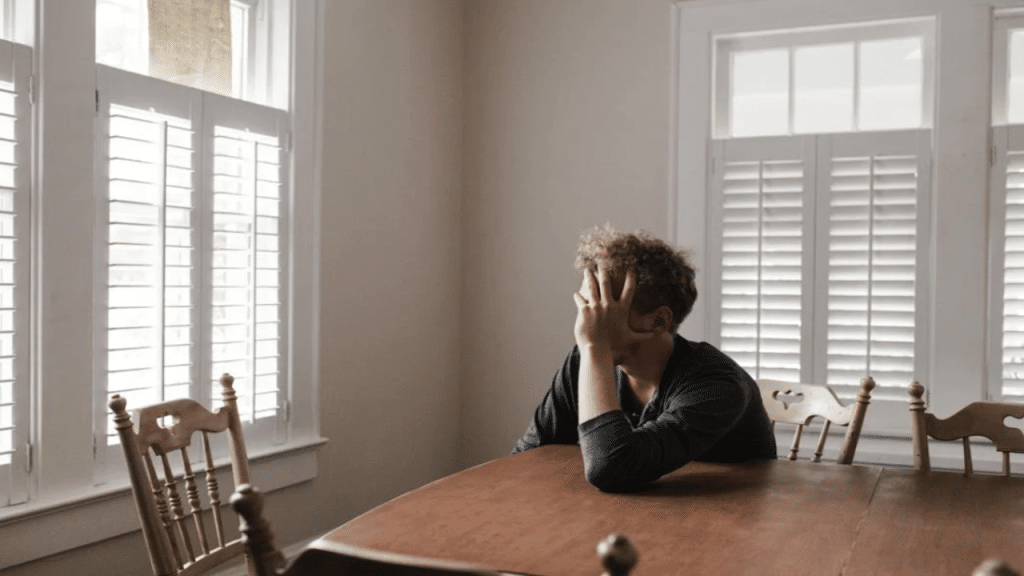 A man looking upset at home