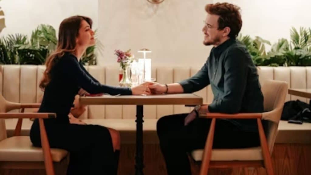 Couple sitting at a table, talking calmly and smiling