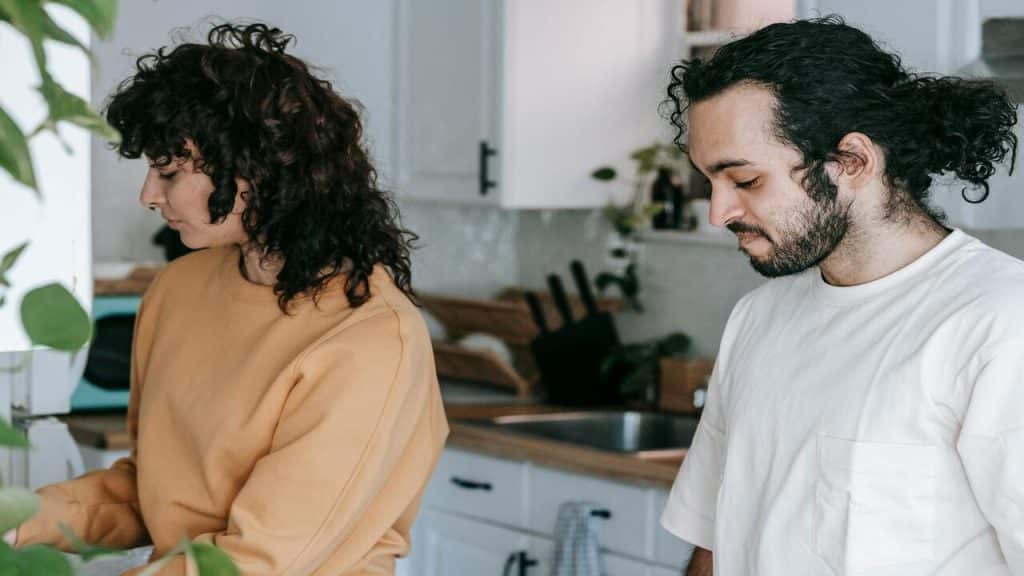 A couple quietly doing chores