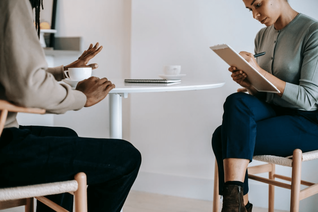 Female consultant talking to client and taking notes