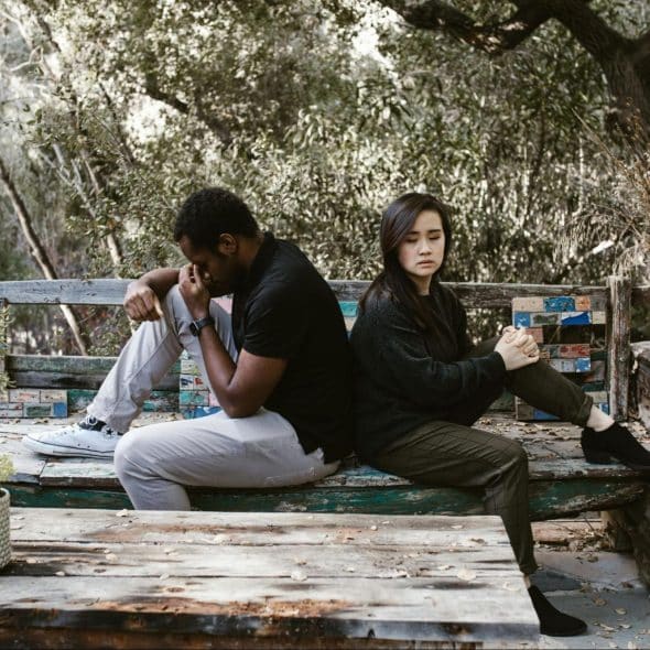 A man and woman sitting and facing opposite directions