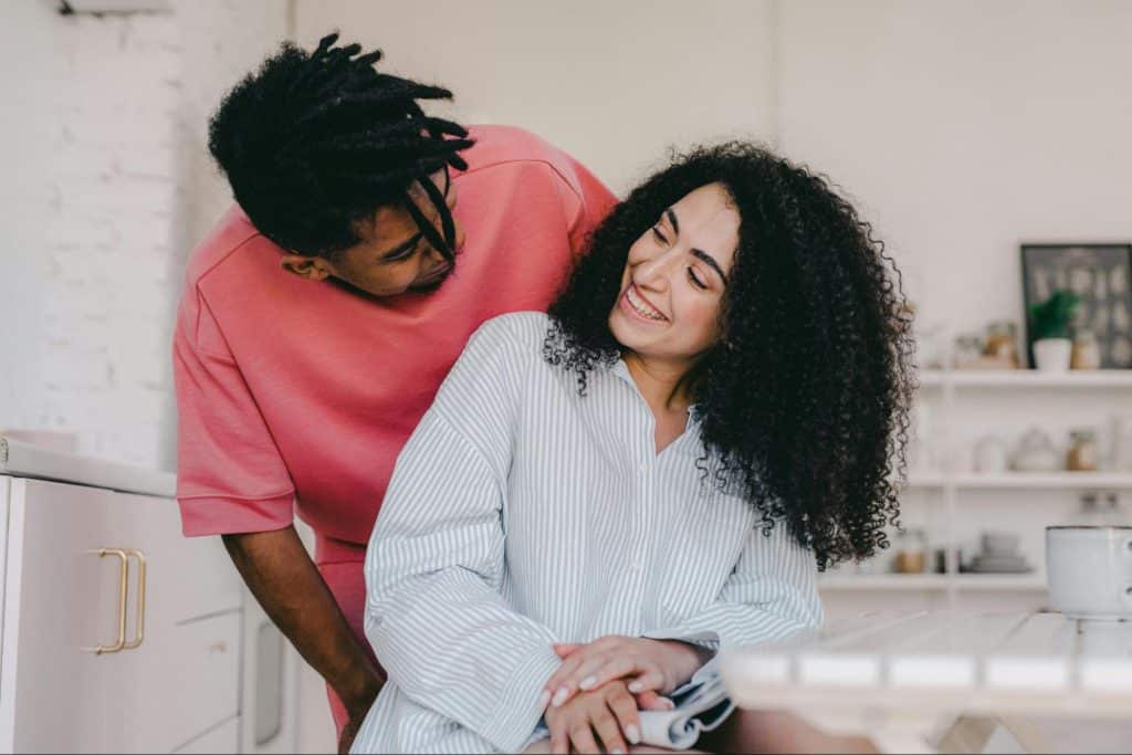 A man smiling at the woman