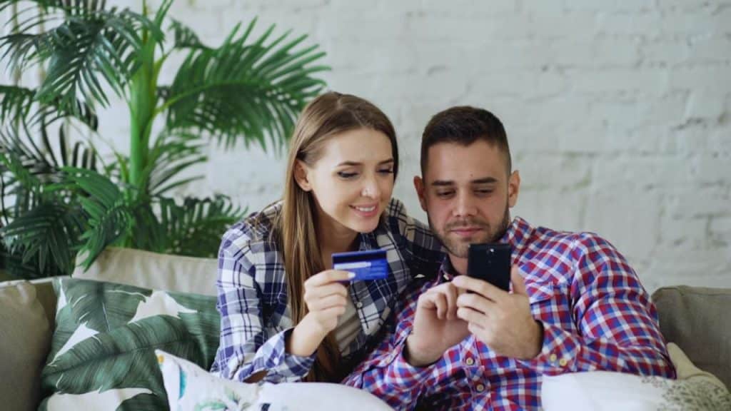 Couple reviewing expenses together on a smartphone
