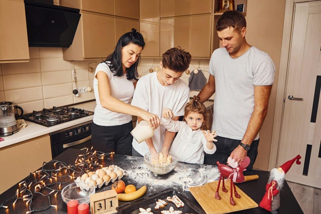 The young family is preparing food together.