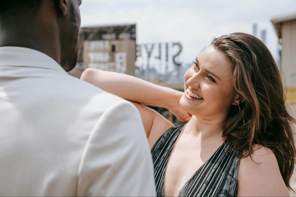 A woman looking at the man