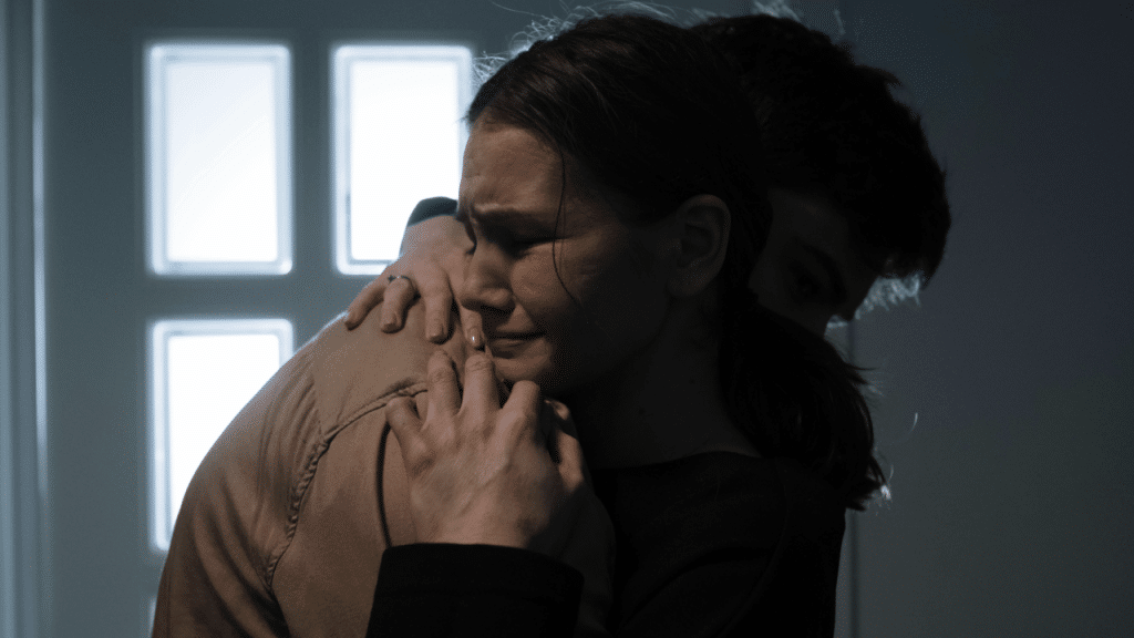 A man hugging his upset wife