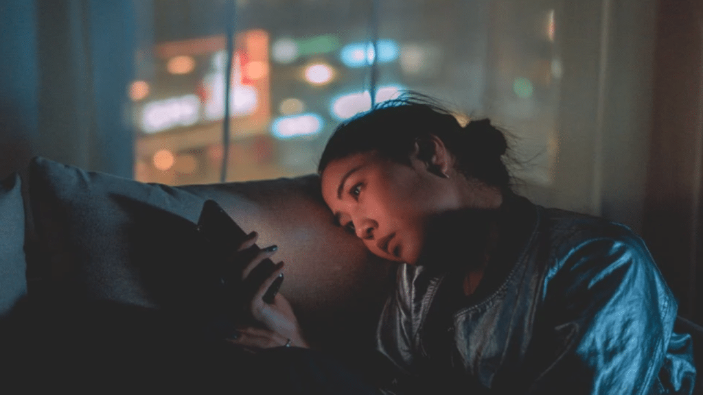 A woman looking pensive while texting