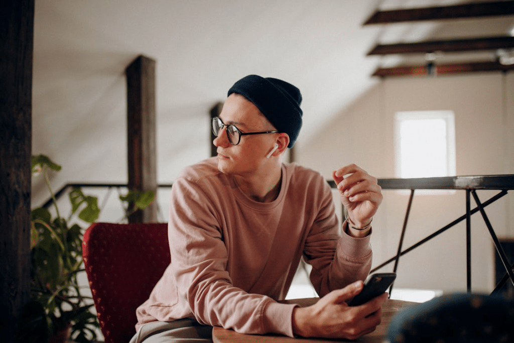 Man in Sweatshirt Sitting at Table