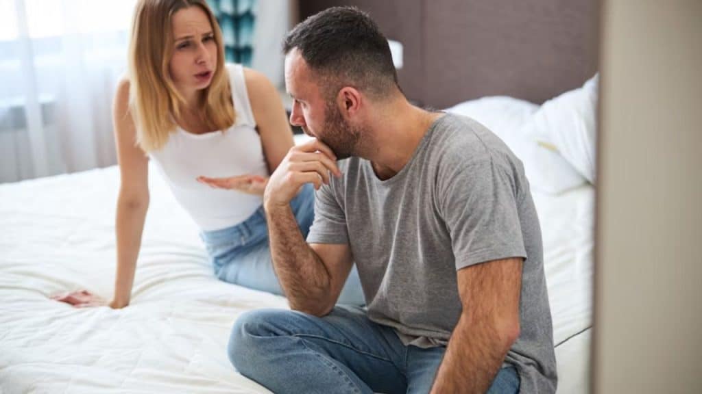 Man trying to calm his partner during a heated discussion