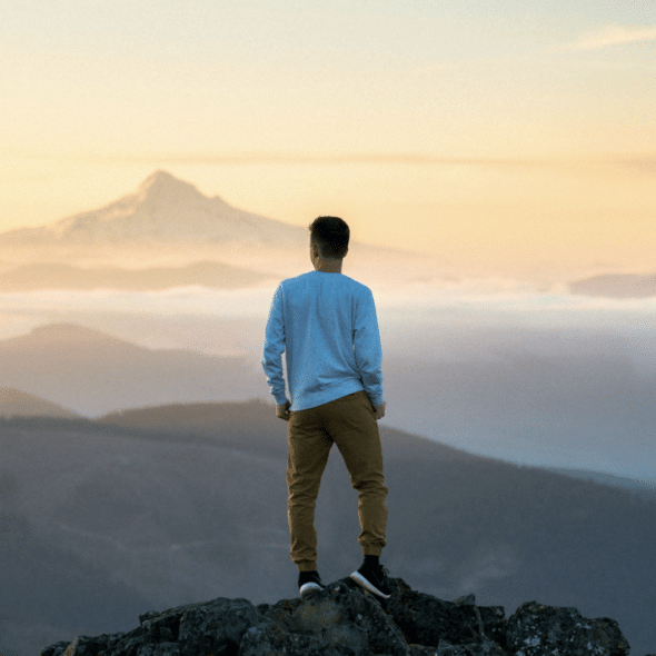 A man standing on top of a mountain