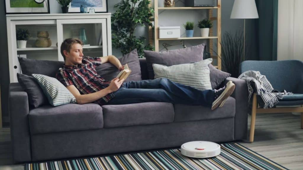 Man relaxing on a couch with a book
