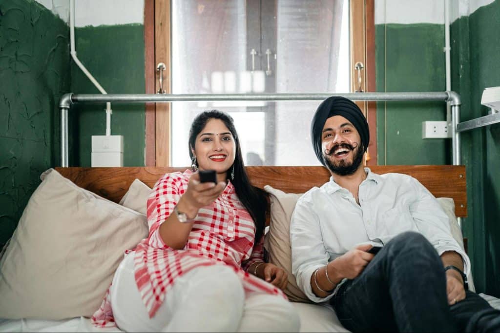 A man and woman watching a tv