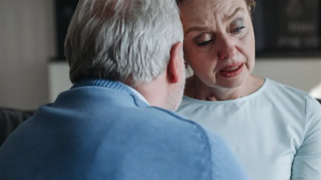 A man comforting his crying wife