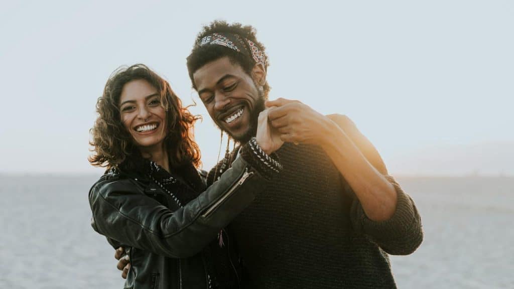 A couple smiling and dancing together on the beach.Chemistry can trick you into thinking you’ve found something special. You mistake excitement for compatibility and hope the rest will sort itself out. But once the spark fades, reality kicks in.
