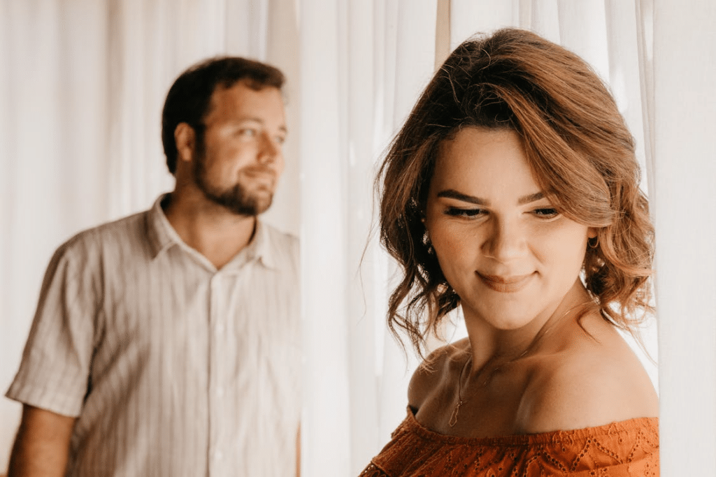 Man and Woman Posing near the Curtains