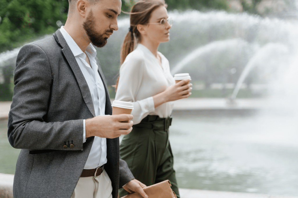 Man and woman walking past the fountain