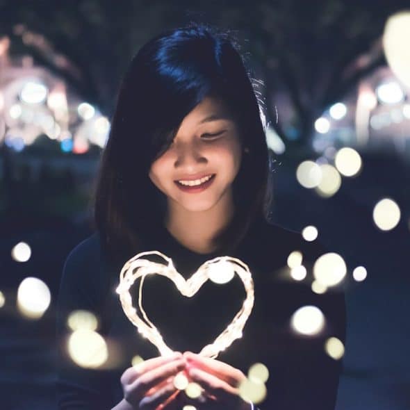 A woman holding a heart.