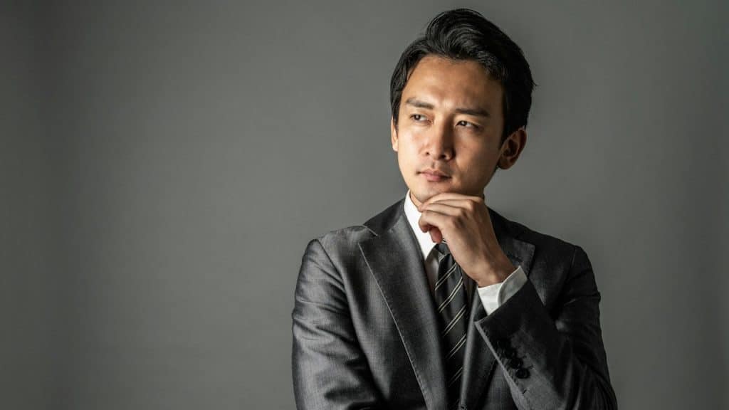 A man wearing a suit thinking deeply.