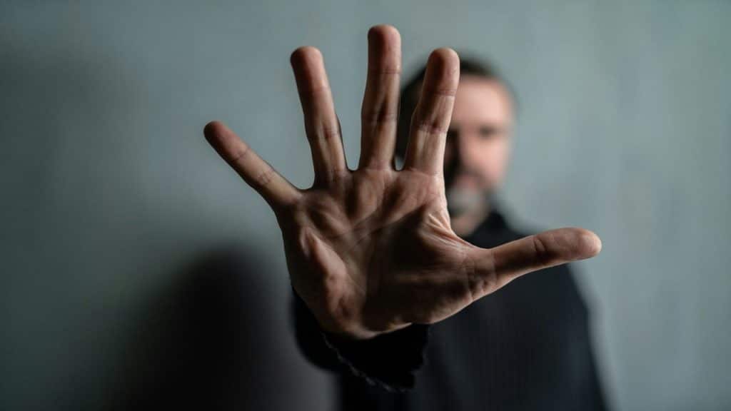 A man saying “no” with his hand 