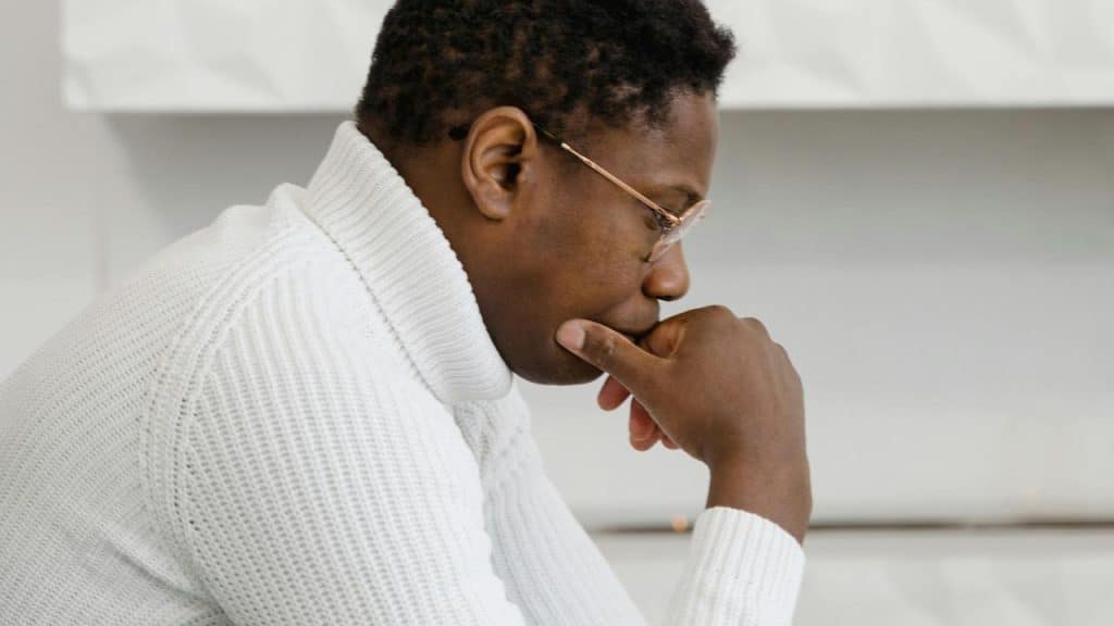 A man sitting and thinking deeply.