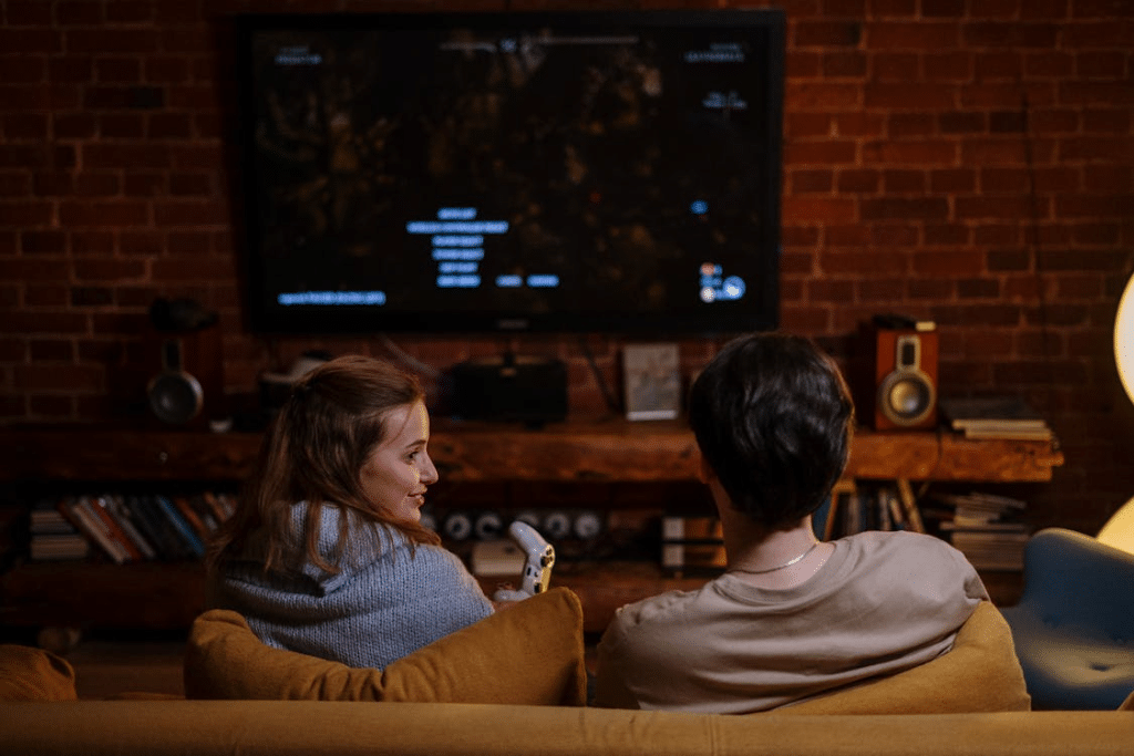 Man and Woman Sitting While Watching a Movie