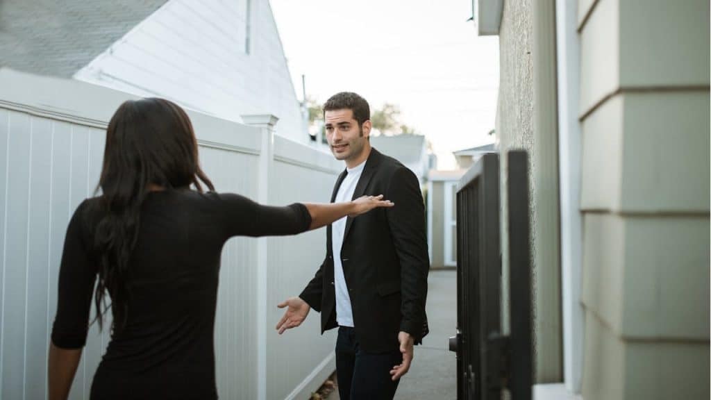 Man arguing with woman outdoors
