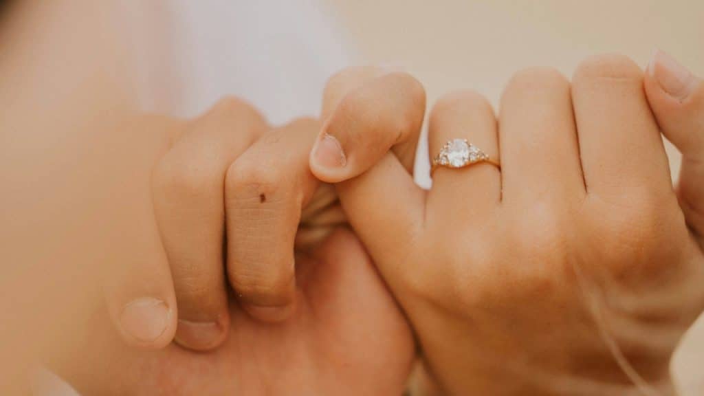 A close-up of a couple doing a pinky promise