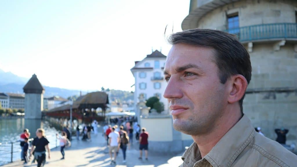 A man is standing in front of a building.