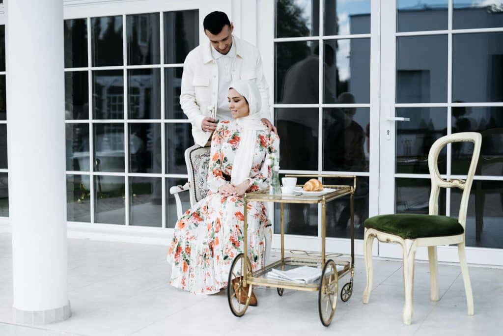 A man holding the shoulder of a woman