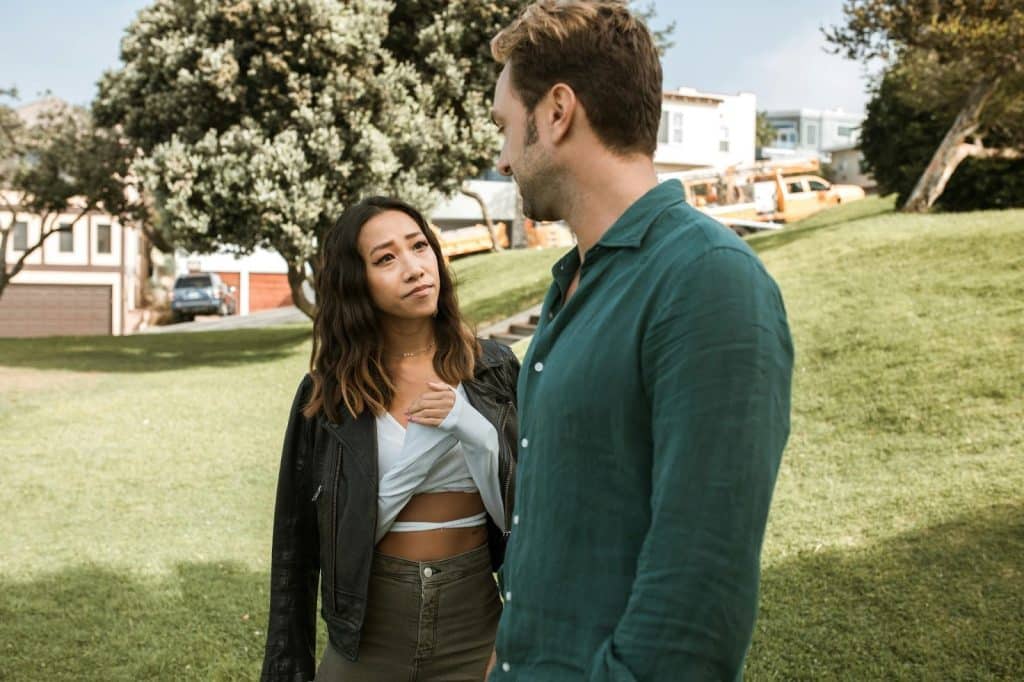 A man and woman facing each other