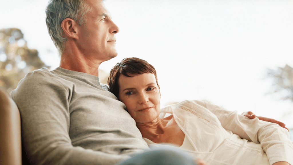 A couple cuddling on the couch