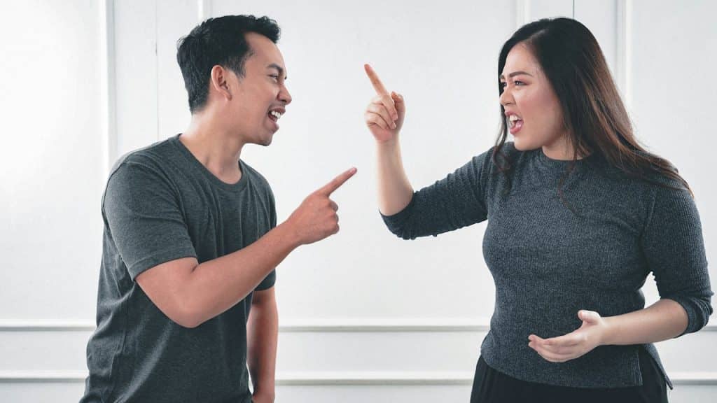 A man and a woman fighting with each other.