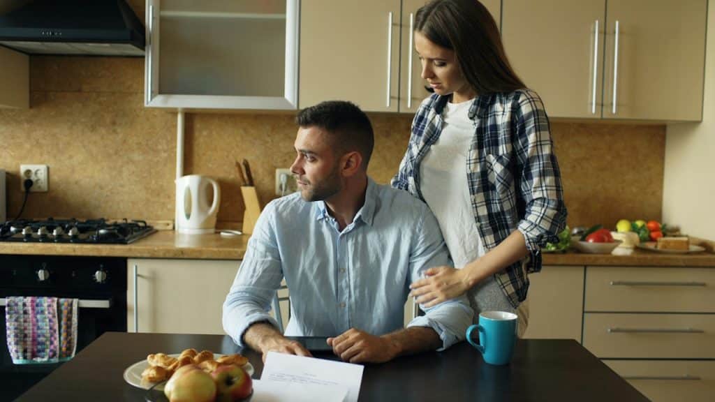 A man is worried after checking monthly bills.