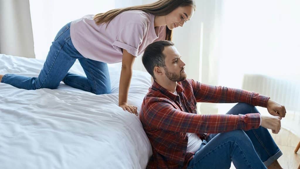 A woman looking at her husband for attention.