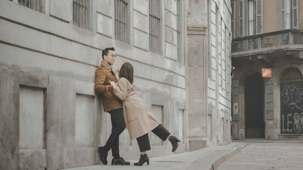 A man and a woman standing outdoors.