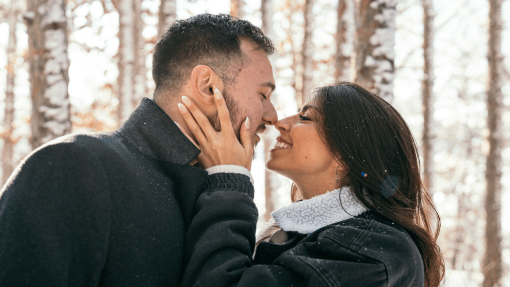 A couple about to kiss in the snow