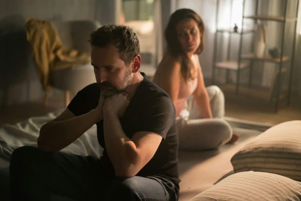 A man thinking and a woman behind him