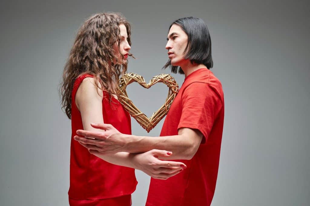 A man and woman facing each other