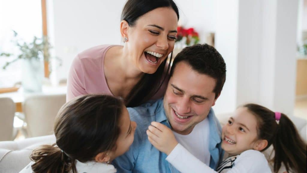 A family laughing together and spending time at home.