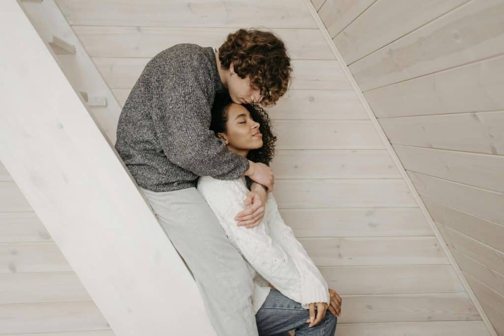 A man hugging a woman