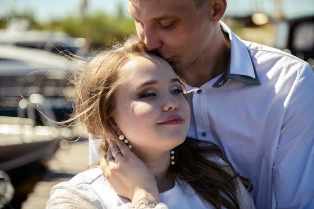 A man kissing a woman’s face 