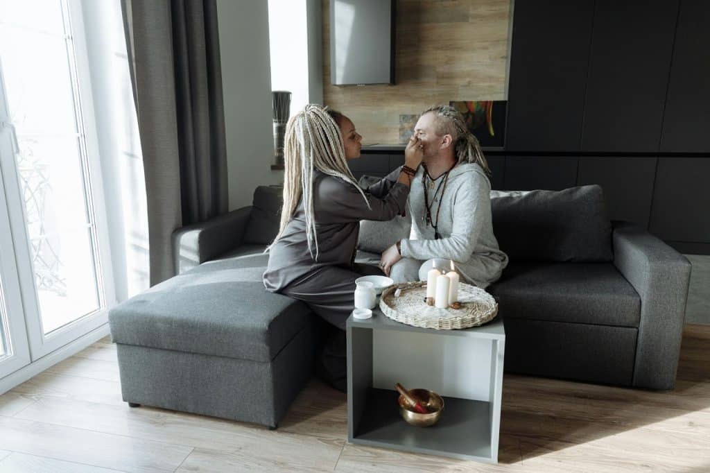 A woman cleaning a man’s face