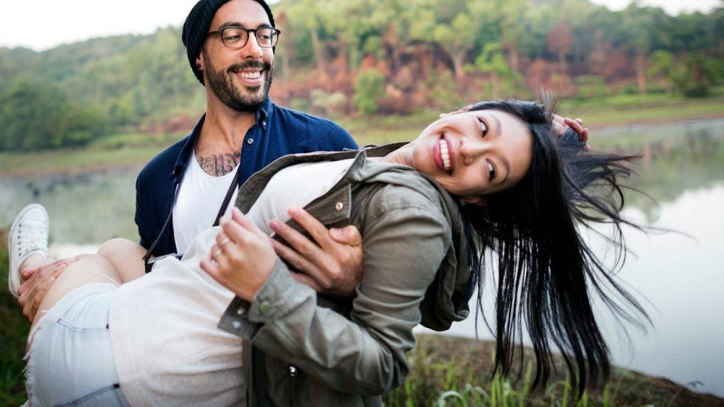 A man holding a woman in her lap.