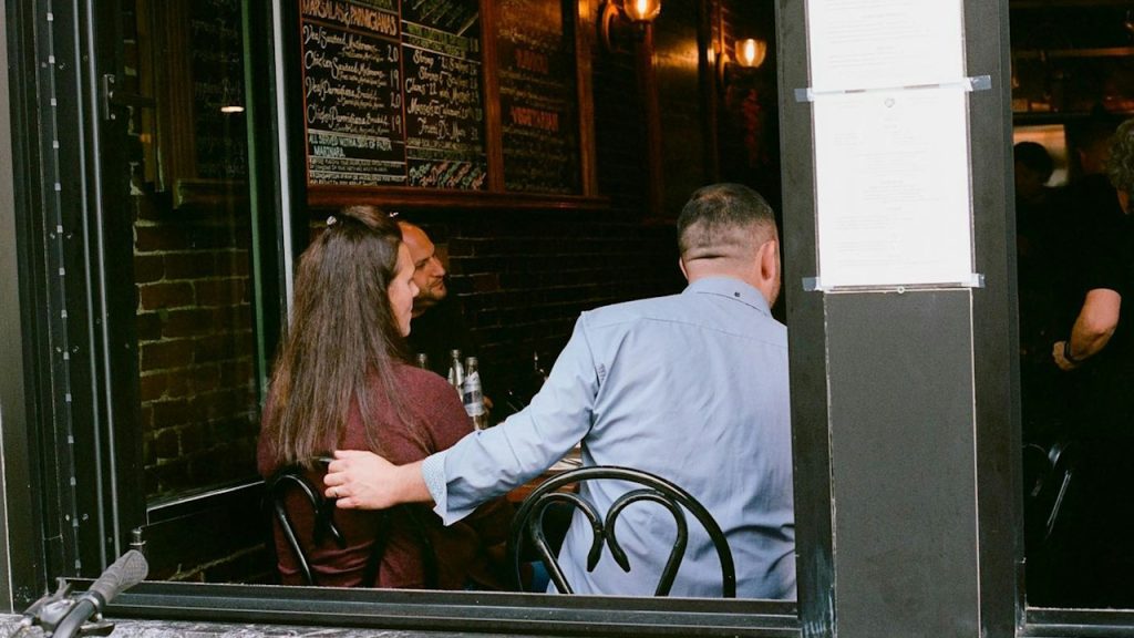 A man and a woman sitting at a table in a restaurant.