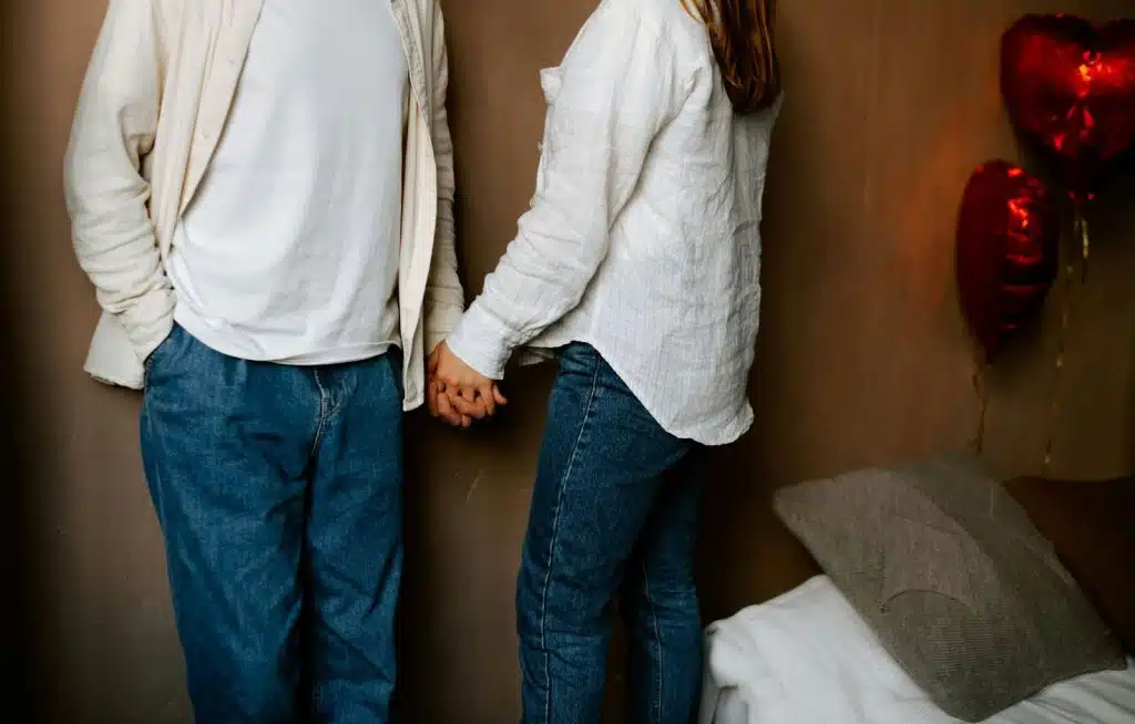 A man and woman standing and holding hands