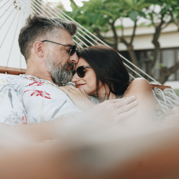 A couple relaxing on a hammock