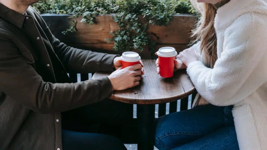 A couple talking over coffee