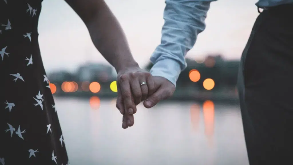 A couple showing off their engagement ring
