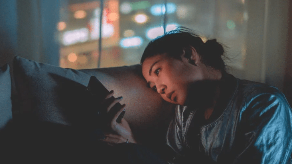 A woman looking sad while texting